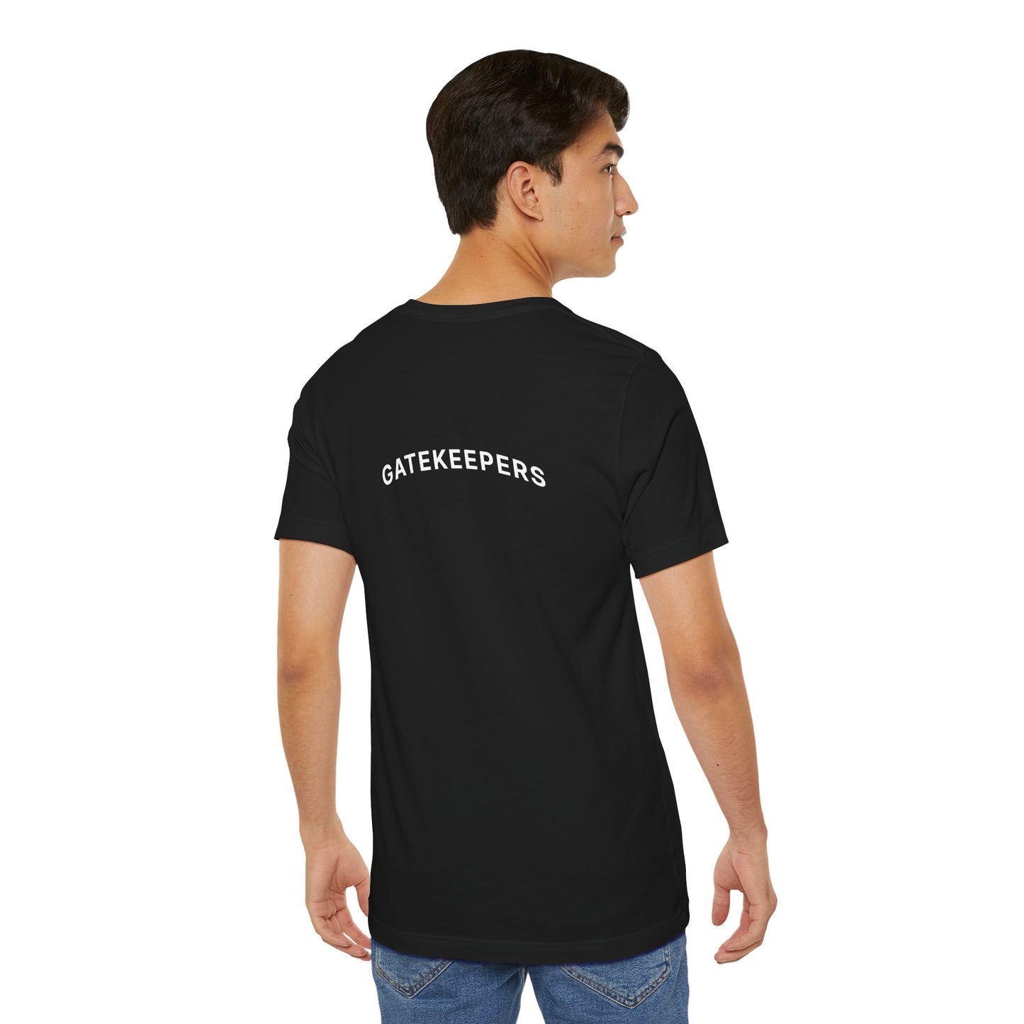 Person wearing a black t-shirt with 'GATEKEEPERS' text on the back, standing against a white background