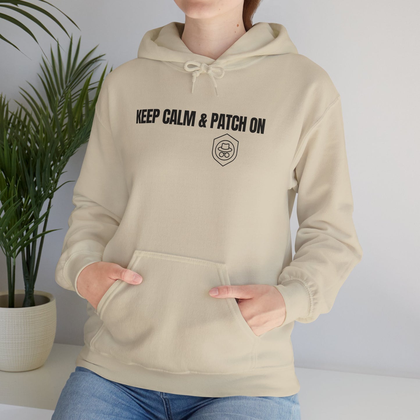 Sand-colored hoodie with 'Keep Calm and Patch On' slogan. Front view.