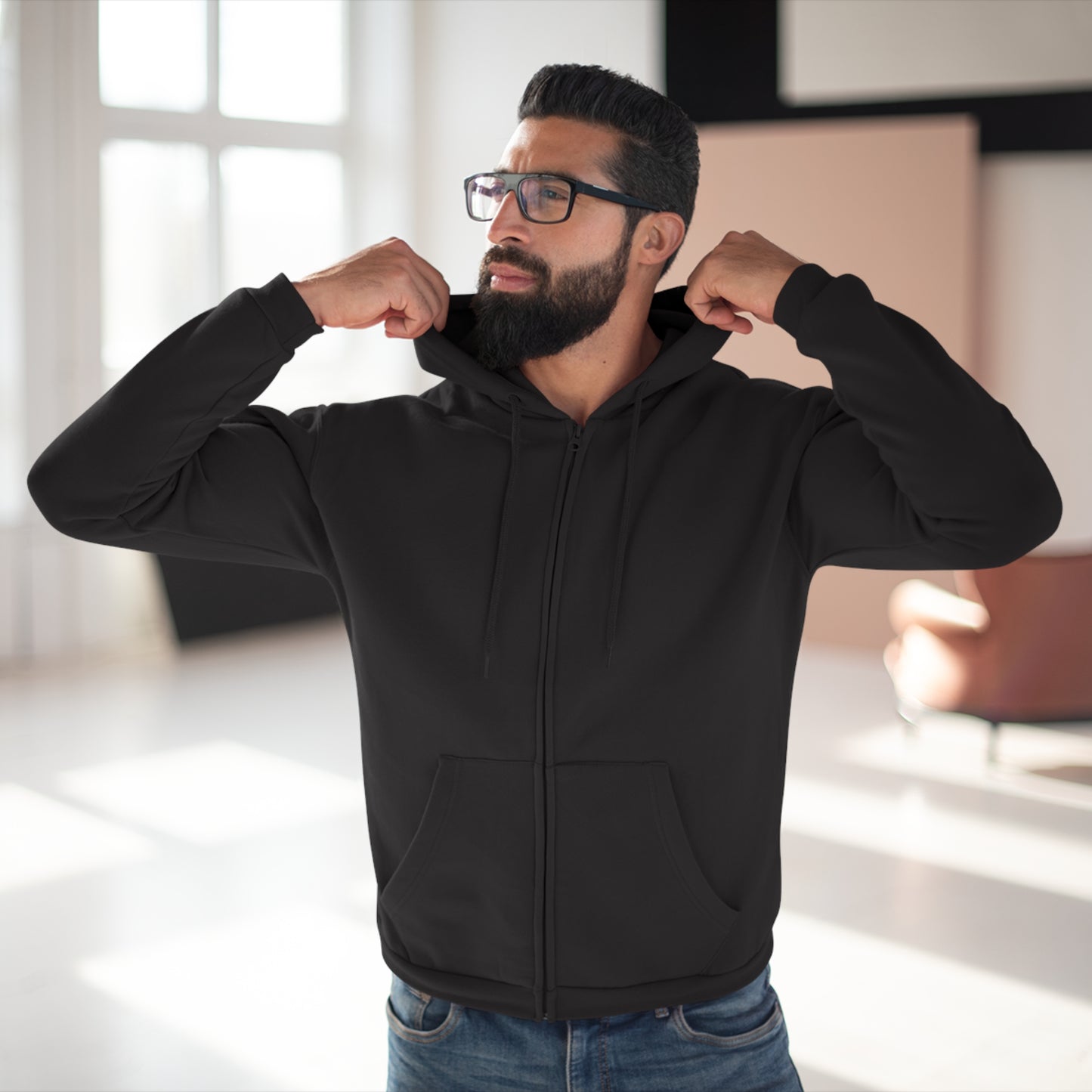 Man wearing a black hoodie in a bright room