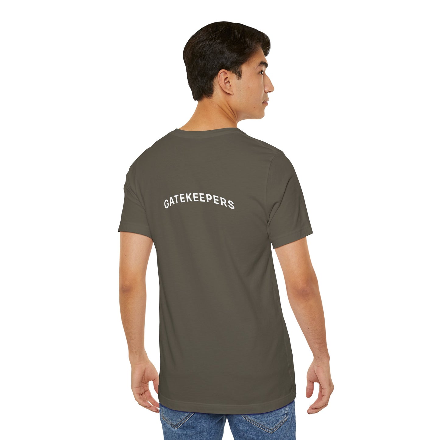 Person wearing a khaki t-shirt with 'GATEKEEPERS' text on the back, standing against a white background
