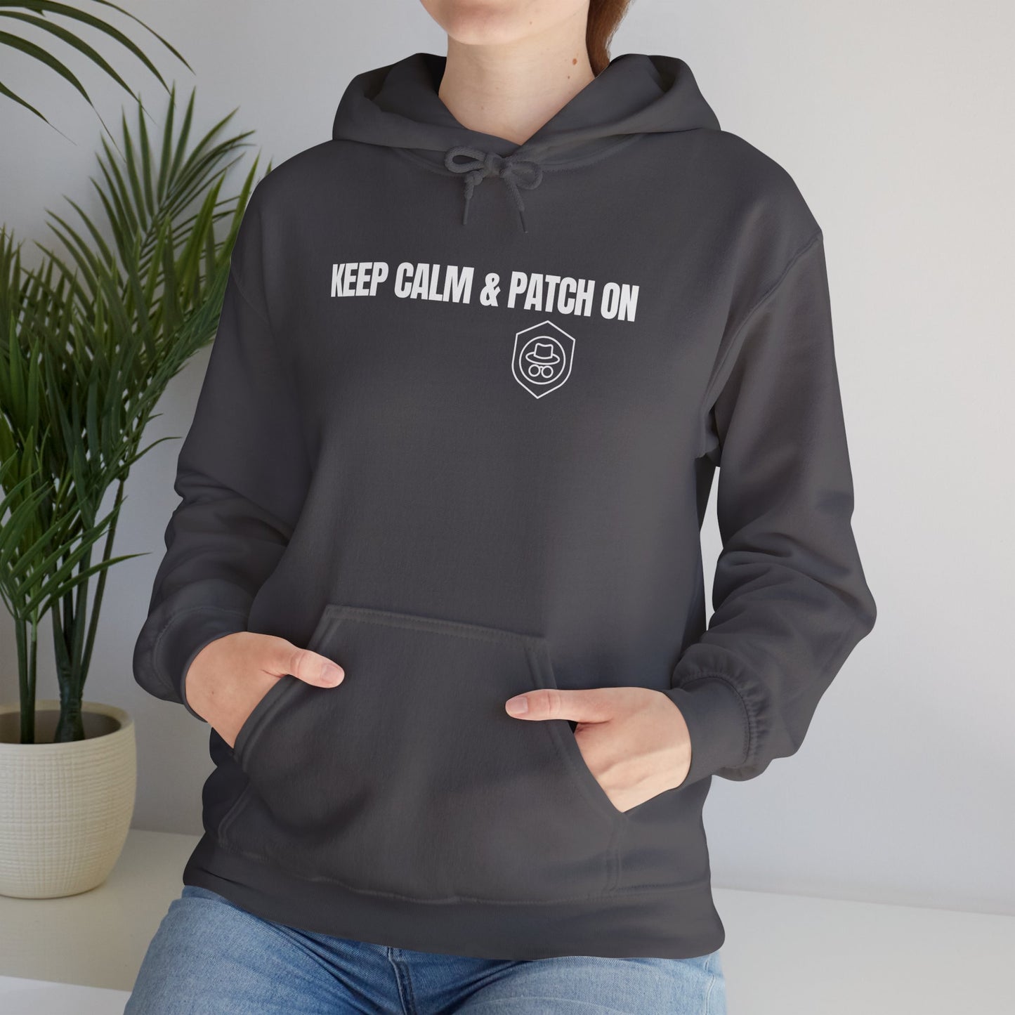 Charcoal gray hoodie showcasing the 'Keep Calm and Patch On' slogan. Front view.