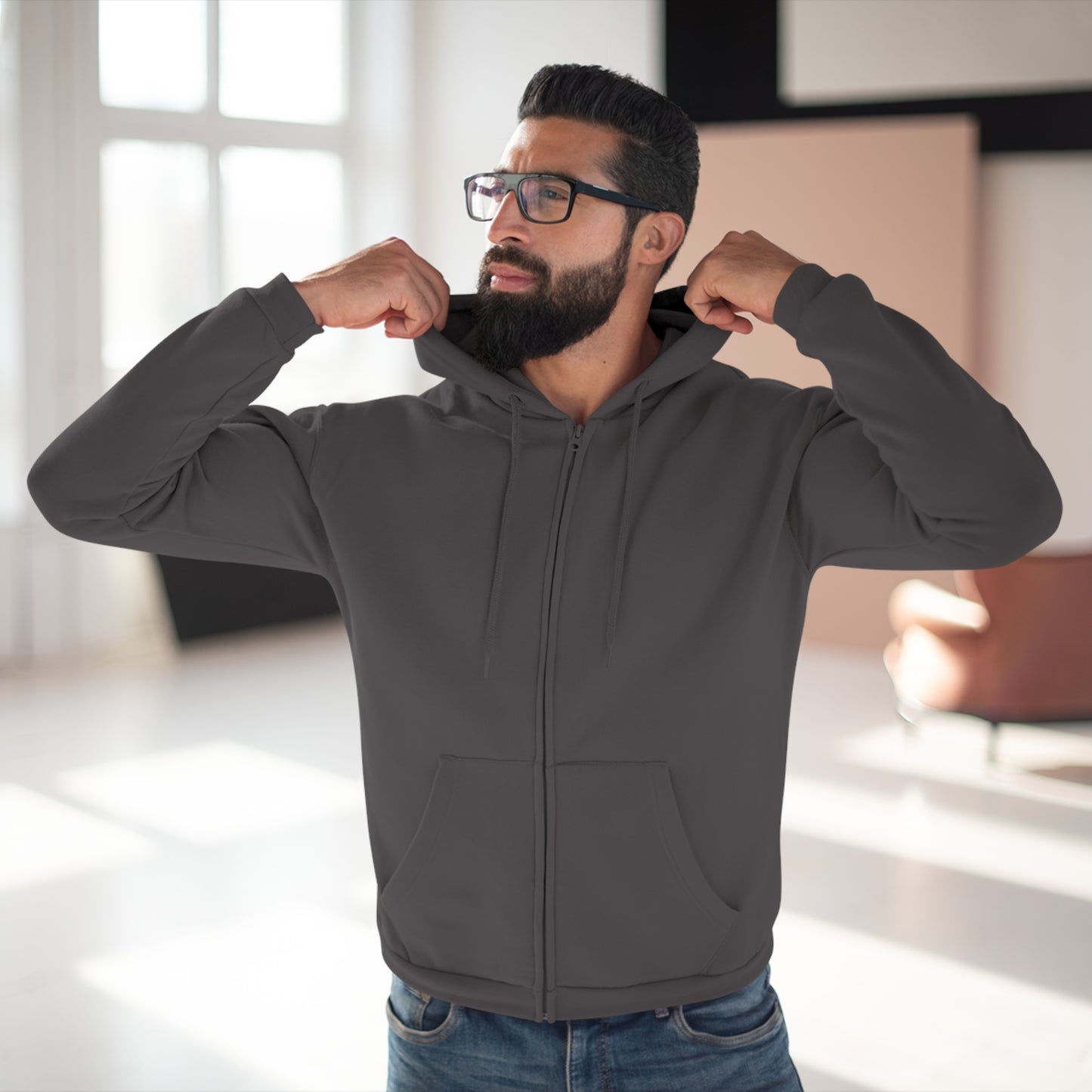 Man wearing a gray hoodie in a bright room
