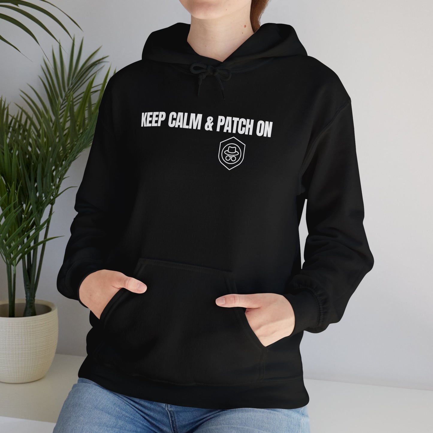 Black hoodie displaying the 'Keep Calm and Patch On' slogan. Front view.