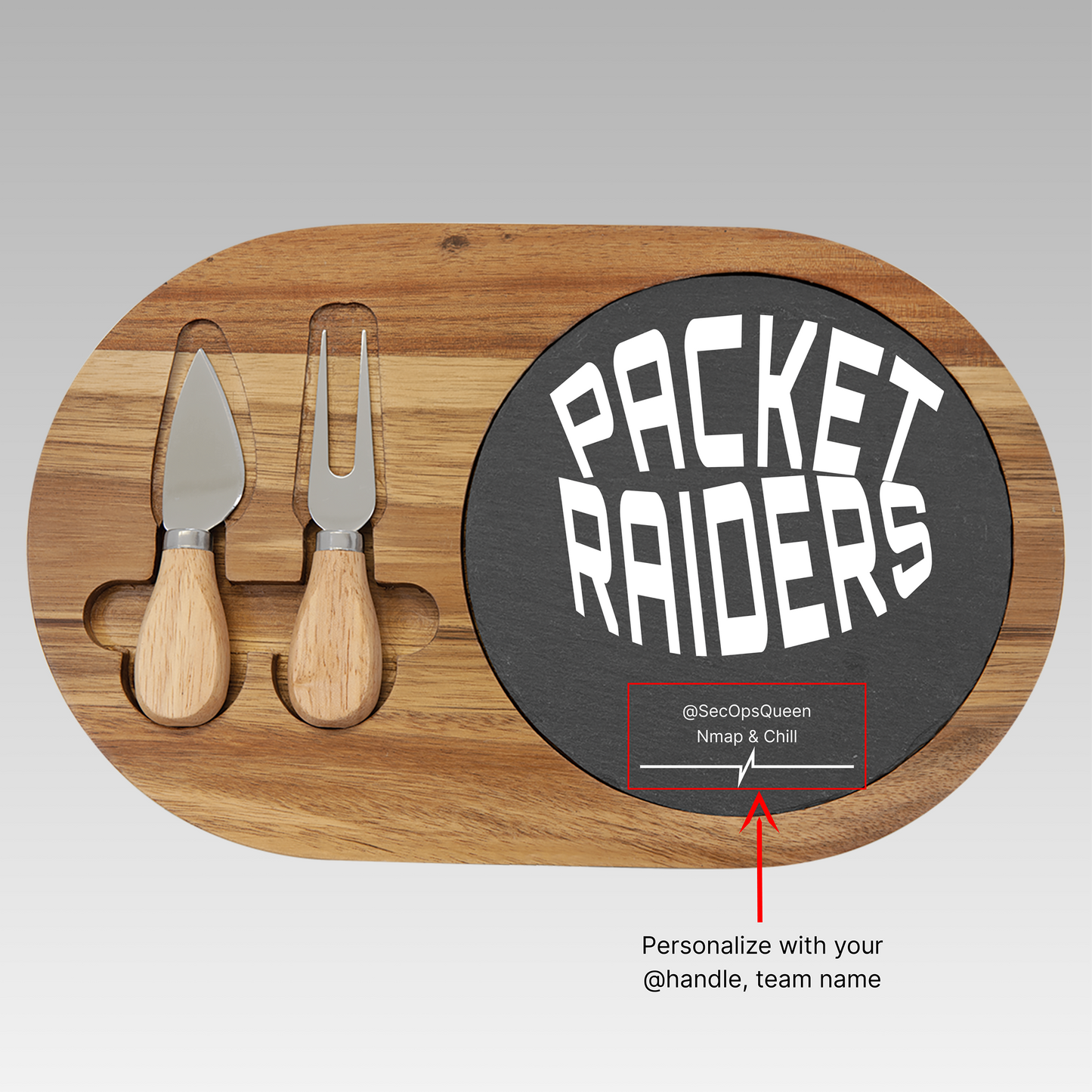 Customizable, oblong, wooden charcuterie board with cheese knife and fork, and a black round slate with sign 'Packet Raiders' text.