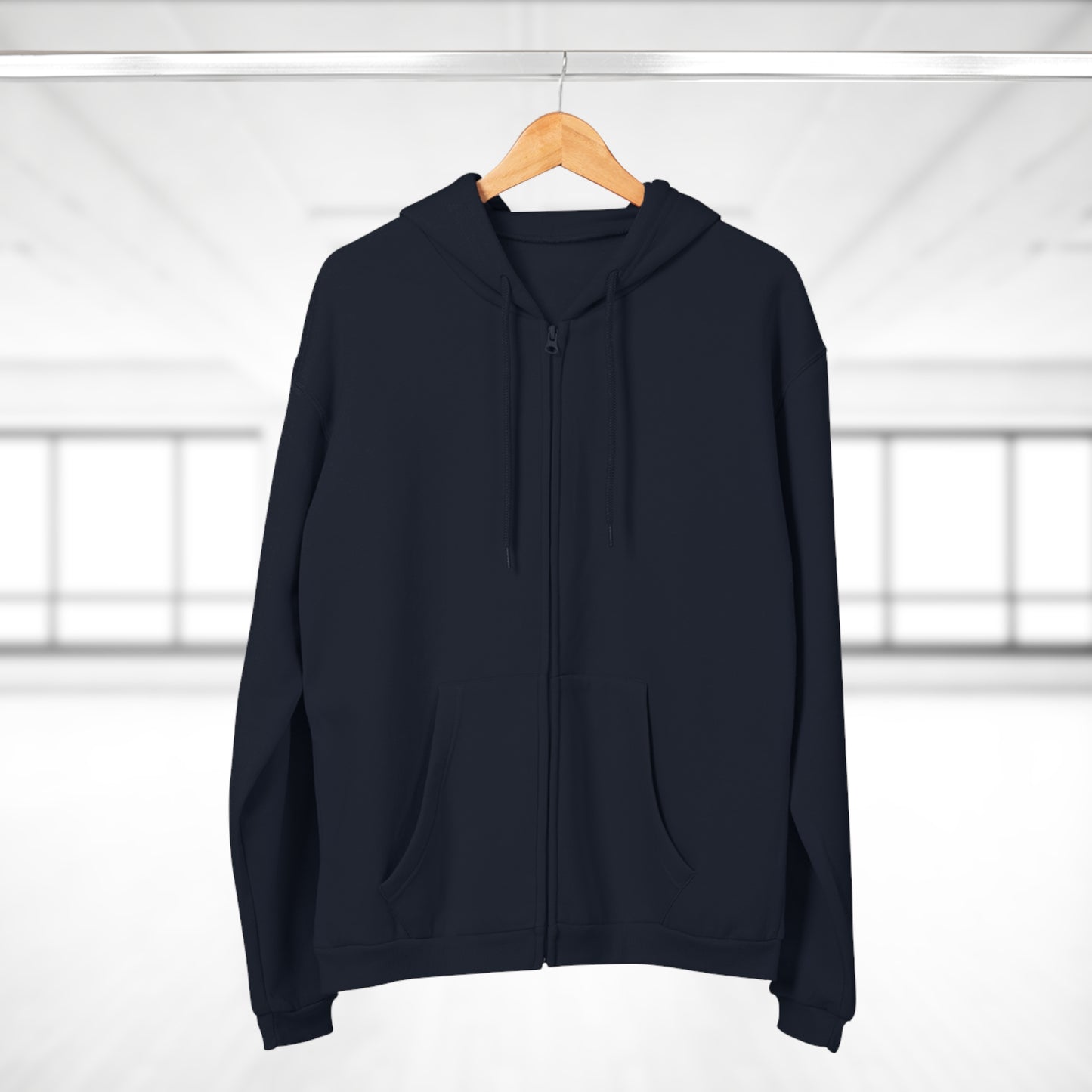 Black hoodie on a wooden hanger against a white background