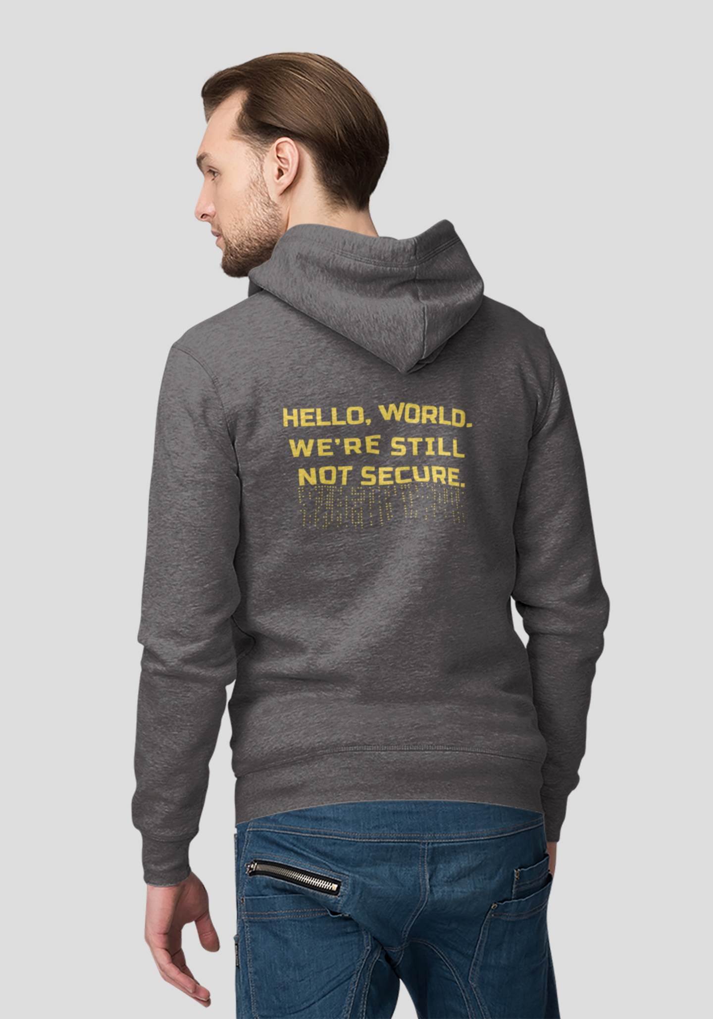 Person wearing a gray hoodie with yellow text on the back, standing against a light gray background