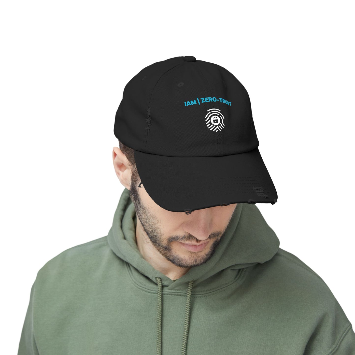 Man wearing a black cap with a logo and text, looking down on a white background