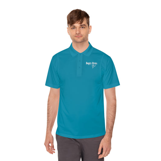 Man wearing a vibrant tropic blue polo shirt, standing outdoors against a white background