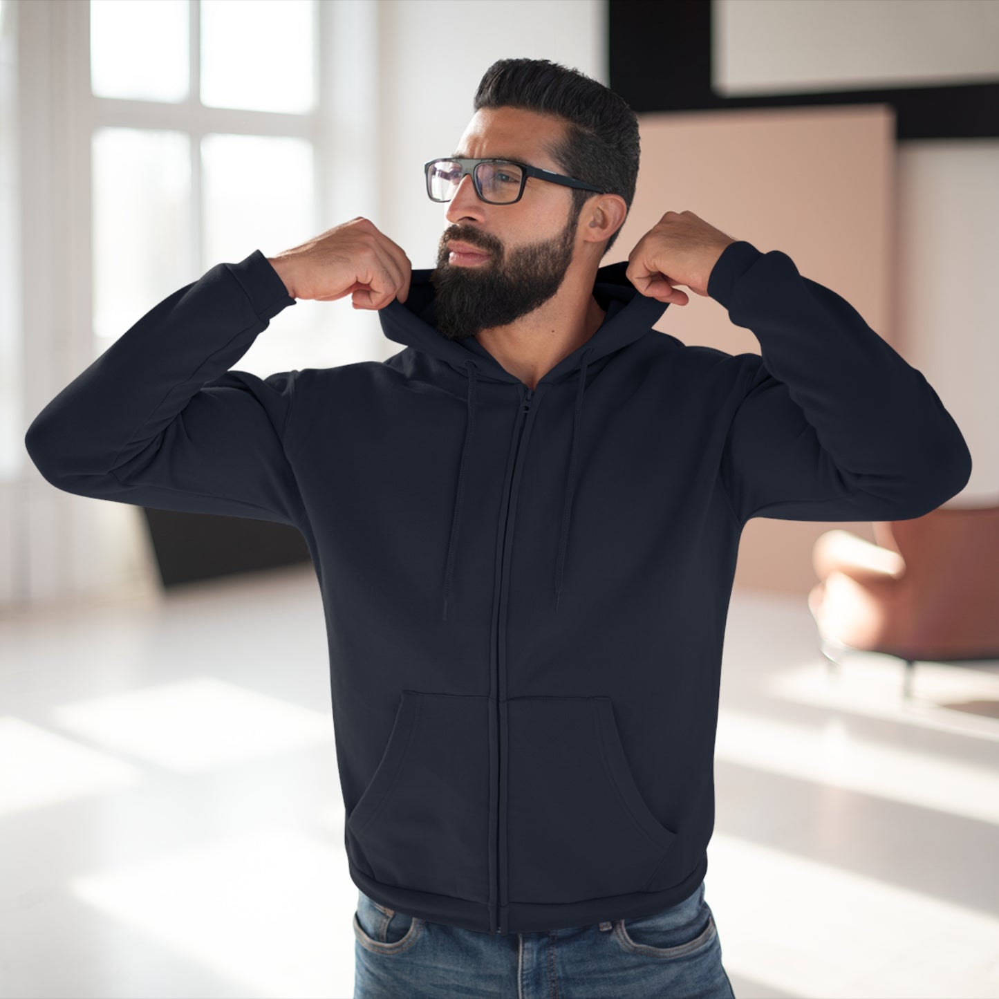 Man wearing a navy blue hoodie in an indoor setting
